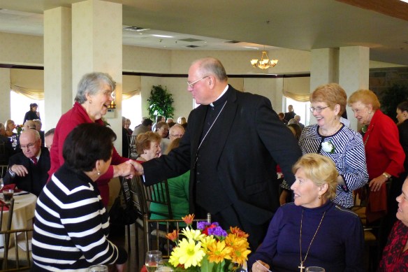 Timothy Cardina Dolan, Archbishop of New York, greets Ann O'Connor, one of the orignal Birthright volunteers.