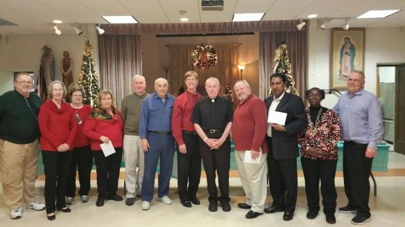 At the Triune Council Christmas Party (L to R) Chet Nawoichyk (the Fisher Foundation), Liz O'Brien (Rockland RTL), Peg Beirne (Rockland Catholic Coalition), Ellen Traina (Birthright), Pete Noonan (COPS Barn), Di Felice (Financial Secretary), Kevin McGovern (COPS Barn), Msg. John J. O'Keefe (pastor of St. Margaret's) John Rio (Grand Knight), Joe Jacobs (Divine Providence), Nannette Morris (Good Counsel) and Bill Palino (Rockland Sister Cities Project)